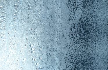 Frozen drops of condensation on a window, a sharp drop in temperature, sharply frozen drops of water on glass in winter, extremely cold low air temperatures