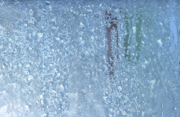 Natural frozen drops of condensation on transparent glass. Beautiful background from a frozen...