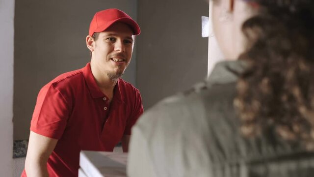 home delivery - courier delivers pizzas to a young woman