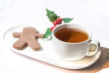 Gingerbread cookie with a cup of tea on a white background, isolated, close up, holiday season