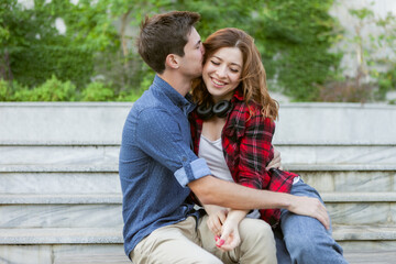 Fototapeta premium Young attractive couple of lovers spend time together outdoors. Happy, funny people. Love concept.