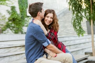 Young attractive couple of lovers spend time together outdoors. Happy, funny people. Love concept.