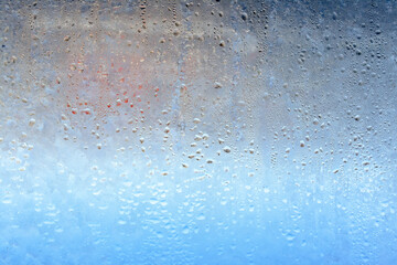 Natural frozen drops of condensation on transparent glass. Beautiful background from a frozen...