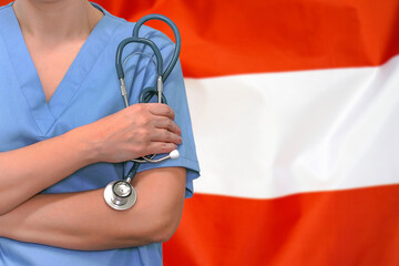 Female surgeon or doctor with stethoscope in hand on the background of the Austria flag. Surgery concept in Austria