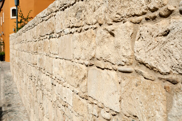 Natural stone wall in sunlight