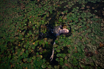 beautiful girl bathes in a swamp, a mermaid in a swamp.
