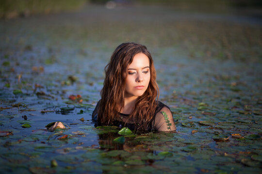 beautiful girl bathes in a swamp, a mermaid in a swamp.