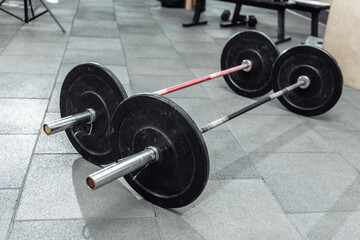 Obraz na płótnie Canvas Two heavy barbells are on the floor in the gym. Bodybuilding and Fitness