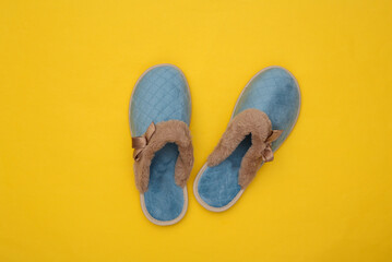 Women's sleeping slippers on yellow background. Top view