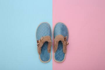 Women's sleeping slippers on a blue-pink pastel background. Top view