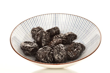 Sweet organic prunes, close-up, on a white background.