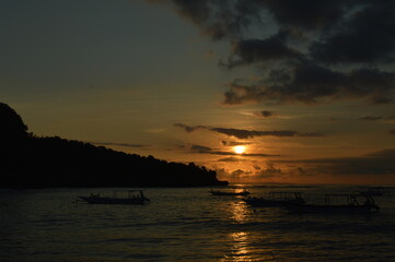 amazing sunset with boat in bali island