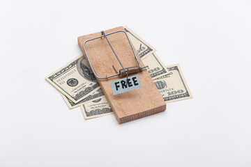 Mousetrap with free bait and dollar bills on white background. Trap, risks or deception concept