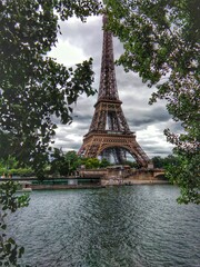 Fototapeta na wymiar Eiffel Tower with Seine river viewed through trees