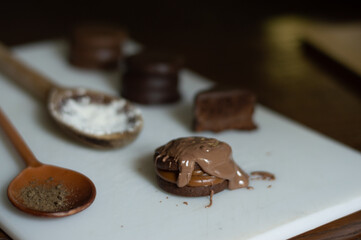 Uruguayan and Argentinian alfajor in dark scenery. Typical South American food. Chocolate cake with dulce de leche filling. Uruguay. Argentina