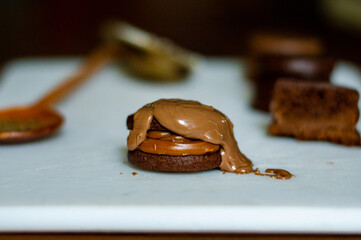 Uruguayan and Argentinian alfajor in dark scenery. Typical South American food. Chocolate cake with dulce de leche filling. Uruguay. Argentina