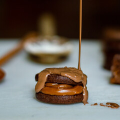 Uruguayan and Argentinian alfajor in dark scenery. Typical South American food. Chocolate cake with dulce de leche filling. Uruguay. Argentina