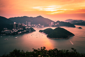 Overlooking view of Middle islands, buildings in seaside at Deep Water Bay, Hong Kong seen form brick hill (nam long shan) in sunrise time