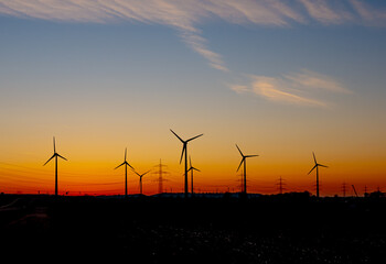 wind turbines at sunset