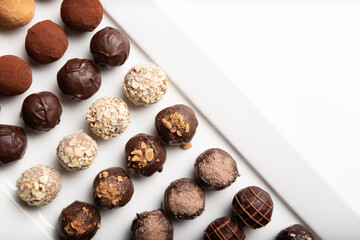 variety of handmade gourmet chocolate truffle candy on a white plate