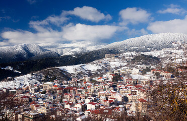 Fototapeta na wymiar Panoramic view of the city of Karpenisi, in Evritania region, central Greece. It is a snowy day in mid January, in the middle of winter.