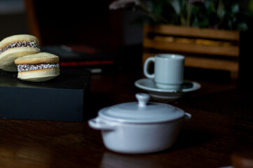 Uruguayan and Argentinian alfajor in dark scenery. Typical South American food. Chocolate cake with dulce de leche filling. Uruguay. Argentina