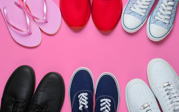 Lot of pairs of shoes on pink background. Minimalistic fashion concept. Top view. Copy space