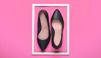 Women's classic high-heeled shoes on pink background with a white frame. Fashion shot. Creative flat lay. Top view. Minimalism