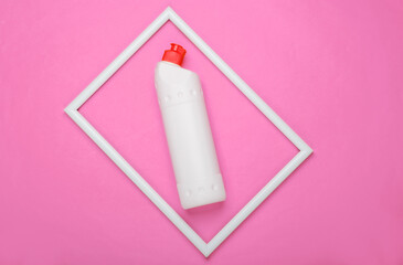 Bottle of detergent on pink background with white frame. Top view. Minimalism