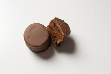 Uruguayan and Argentinian alfajor in dark scenery. Typical South American food. Chocolate cake with dulce de leche filling. Uruguay. Argentina