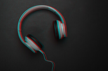Stylish wired stereo headphones on black background. Music lover. Glitch effect