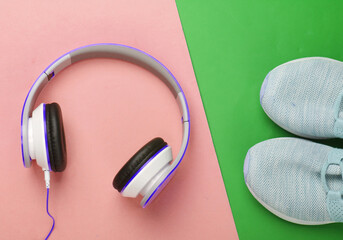 Flat lay sports and fitness composition. Running shoes, headphones on colored background. Top view