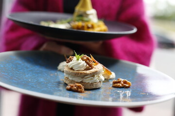 Peanut cake with mascarpone cream and caramel.
Food, a tasty dish served on a plate. A proposal for an application. Culinary photography.