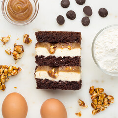 Slice of chocolate and caramel cake. Top view. Slice filling in section on a marble dek.