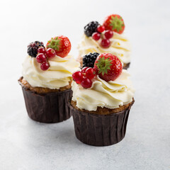 Berry cupcakes on white background