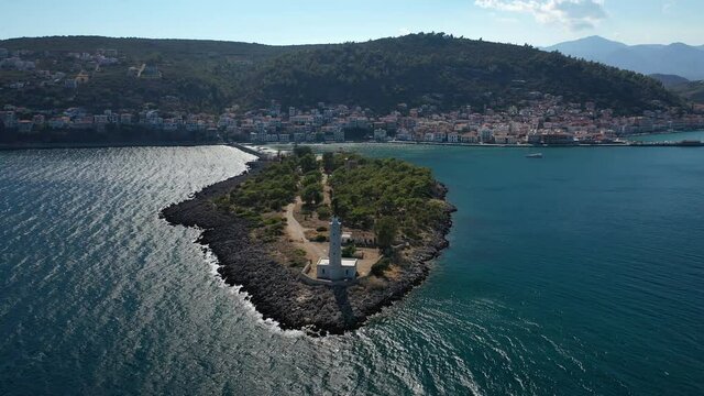 Aerial drone video of famous small islet of Kranai known for old lighthouse and tower of Tzannetakis, Gytheio, Lakonia, Peloponnese, Greece