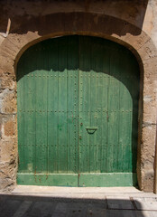 old green wooden door in Spanish town