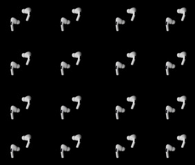 Pattern white wireless headphones on black background.