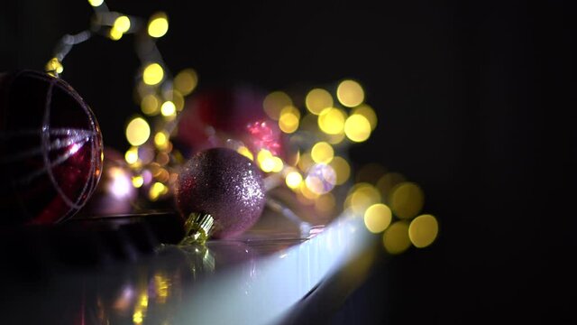Abstract christmas background in bokeh. Lights of blinking garland in blur. Unsharp bulbs of Christmas decorations on the tree. Festive mood. Animated background for text or pictures. New Year holiday