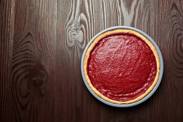 Strawberry pie in baking dish on wooden table background