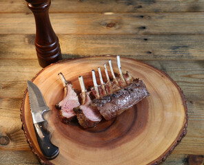 French Rack or Lamb Ribs. Grilled in barbecue in wood background