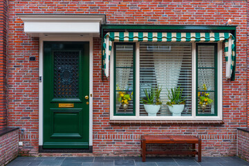 Fototapeta na wymiar Typical Dutch village houses facade. Beautiful and authentic style at Volendam. Netherlands.