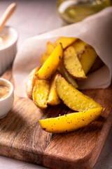 Delicious slices of baked potatoes with rosemary and oil