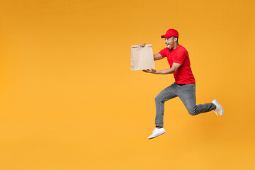 Full length delivery employee african man in red cap blank print t-shirt work courier service hold...