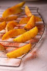 Delicious slices of baked potatoes with rosemary, paprika and olive oil