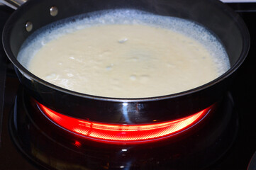 Heating batter in a skillet to make crepes