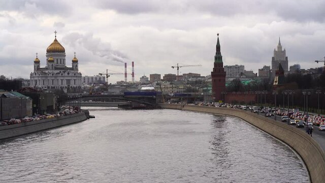 Moscow cityscape in the rainy autumn day. Red Kremlin Towers, Moskva River, Grand Kremlin Palace, traffic at the embankment. 