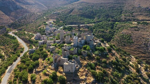 Aerial drone video of abandoned old stone tower village of Vatheia overlooking deep blue sea in Mani Peninsula, Peloponnese, Greece