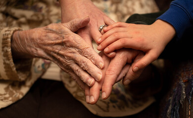 An isolated 95 year old caucasian female suffering from dementia welcomes her great grandchild,...