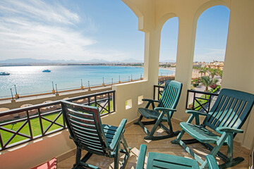 Terrace balcony with chairs in tropical luxury apartment resort